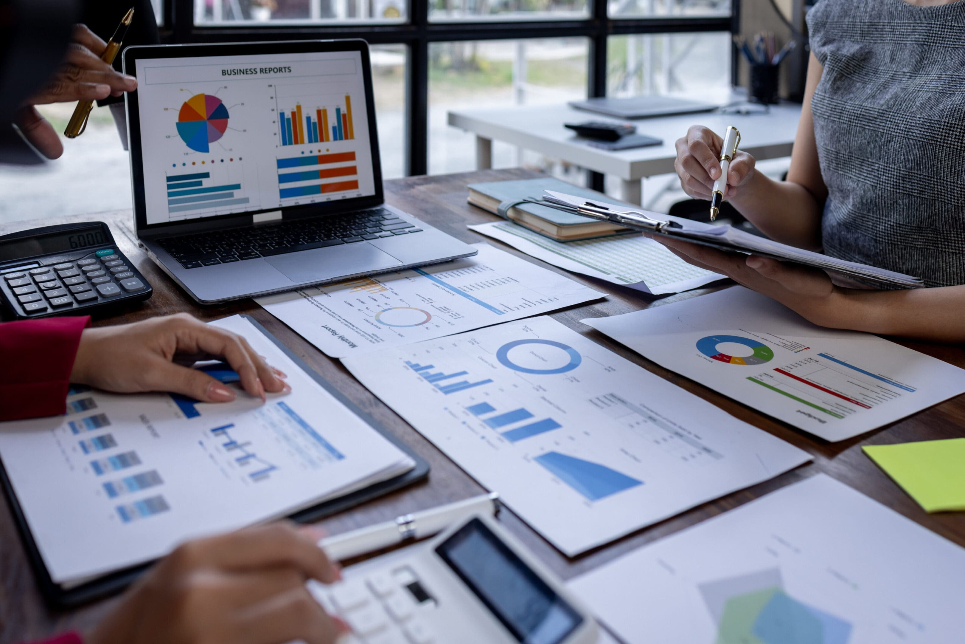 Team analyzing business charts and graphs during a meeting.